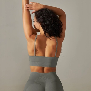 Close-up of ribbed texture and thin straps on a seamless sage green yoga sports bra