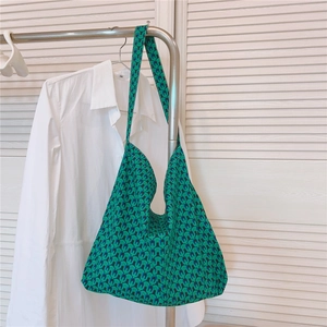 Detailed macro view of green and blue geometric pattern on large canvas hobo tote bag