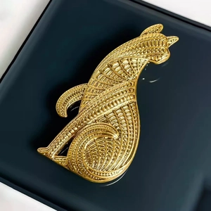 Elegant gold-tone vintage leopard brooch with intricate cutout texture on black surface
