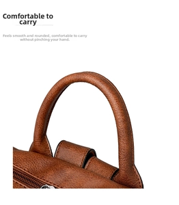Detail of ergonomic brown faux leather handle with neat stitching and smooth metal zipper