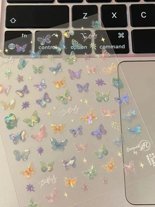 Macro shot of iridescent butterfly and star stickers with holographic laser effect on PET