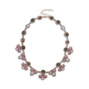 Retro gold necklace with pink resin flowers and rhinestones on a white background