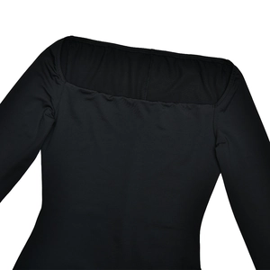 Detail of square neckline and smooth elastic fabric on a black long sleeve bodysuit