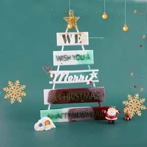 Detailed layered Christmas tree resin ornament with glitter star on a festive background