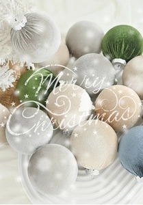 Detail of velvet and striped Christmas ornaments with silver caps on a snowy branch