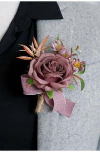 Detail of vintage morandi purple silk rose boutonniere on a grey wool suit lapel