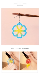 Detailed view of DIY resin heart and flower earrings with glitter finish and metal hooks