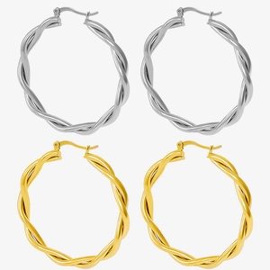 Detailed view of twisted texture on gold and silver stainless steel hoop earrings