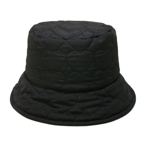 Detail of black quilted bucket hat featuring heart pattern stitching and padded texture
