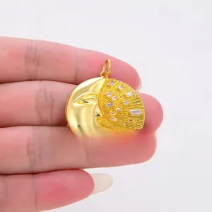 Macro view of a gold circular sun and moon pendant featuring micro-set zircon crystals