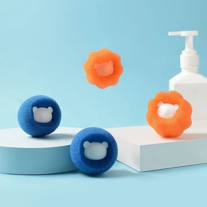 Blue and orange laundry sponge balls with panda motifs for lint and tangle removal