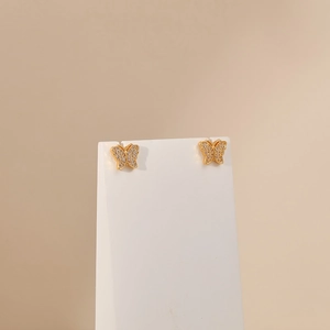 Close-up of gold butterfly stud earrings with sparkling cubic zirconia on display