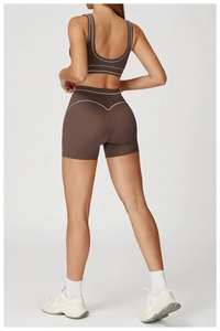 Detail of high-waist sports shorts with heart-shaped back stitching in chocolate brown