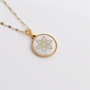 Gold stainless steel necklace with round shell pendant featuring a cutout flower charm