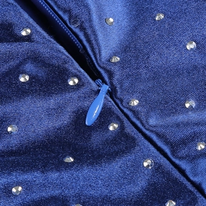 Macro view of blue evening gown featuring silver rhinestones and a hidden zipper detail