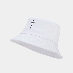 Detailed view of black PEACE embroidery on minimalist white cotton twill bucket hat