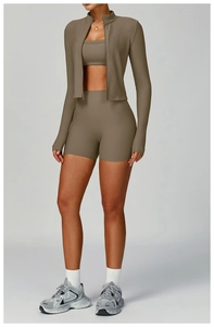 Detailed view of three-piece ribbed yoga set with jacket, sports bra, and high-waist shorts