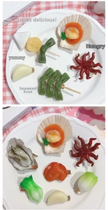 Detailed close-up of novelty resin hair clips shaped like realistic seafood and vegetables