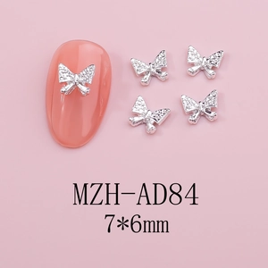 Macro view of silver alloy butterfly nail charms with rhinestones and size label