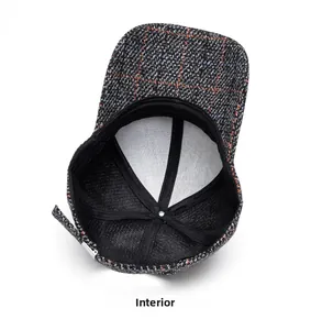 Detail of tweed baseball cap interior featuring a black sweatband and reinforced lining