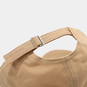 Close-up of khaki cotton twill baseball cap back with adjustable silver metal buckle