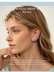 Close-up of minimalist 925 sterling silver star-shaped earring worn on a female model