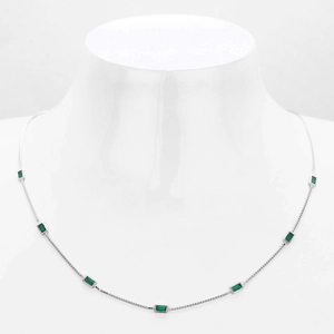 Detailed view of S925 silver necklace featuring seven rectangular emerald green gemstones