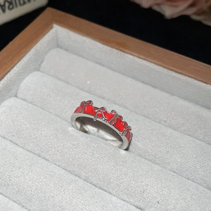 Detail of silver adjustable ring with red enamel and multiple 3D bow accents