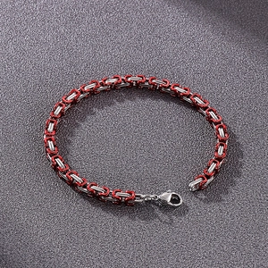 Detail of red and silver stainless steel Byzantine chain bracelet with lobster clasp