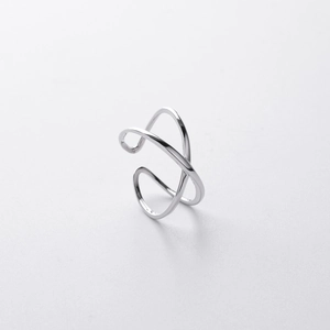 Macro shot of minimalist silver double-layer crisscross open ring with adjustable band