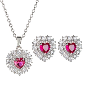 Minimalist silver heart jewelry set with ruby red stones and micro paved crystals