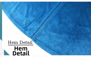 Close-up detail of the hem on a blue velvet medieval hooded cape with neat stitching