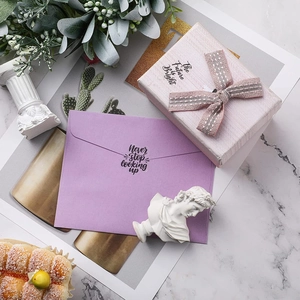 Inspirational stickers gift set with pink bow box and purple envelope on marble