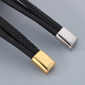 Detail of multi-layer leather bracelet with gold and silver magnetic metal clasps