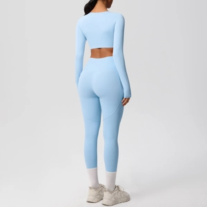 Back view of baby blue two-piece yoga set with long sleeve crop top and leggings