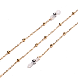 Detail of golden beaded eyewear chain with metallic links and silicone loops
