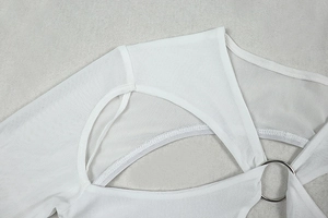 Detail of white mesh knit dress featuring metal ring cutout and open back design