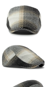 Close-up of vintage tweed flat cap featuring classic grey herringbone and houndstooth patterns
