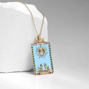 Macro detail of gold tarot pendant featuring sun and wolf motif with the moon text