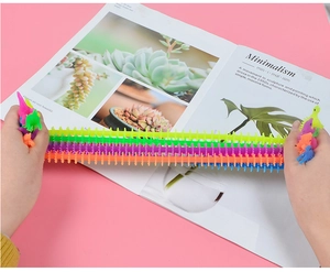 Close-up of hands stretching colorful elastic TPR dinosaur fidget toy for stress relief