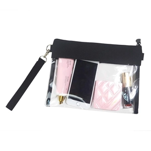 Detailed view of clear PVC makeup bag with black trim and wrist strap showing capacity