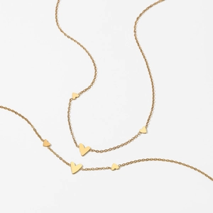 Minimalist gold heart chain necklace made of durable stainless steel on a white background