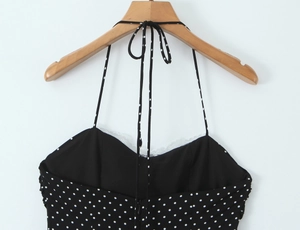 Detailed view of polka dot halter top with white lace trim and adjustable neck ties