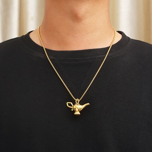 Golden Aladdin genie lamp pendant necklace with celestial star moon relief worn on model