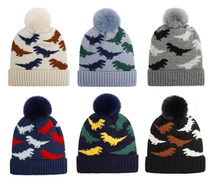 Detail of baby knitted dinosaur hats in six colors with fluffy pom-poms and fleece lining