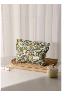 Floral makeup bag on wooden tray featuring H&R BAG label and premium fabric texture