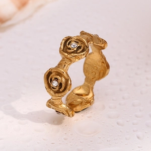 Detail of 18K gold plated stainless steel rose ring featuring a crystal center with water drops