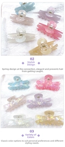 Close-up of assorted laser acrylic hair claws with pearlescent finish on lace fabric