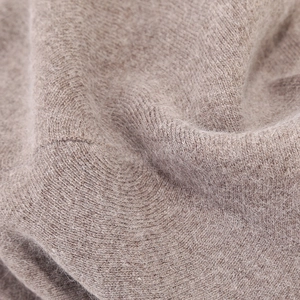 Detailed macro view of high-quality light oatmeal rabbit fur texture on a beret hat