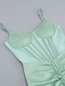 Detail of mint green satin corset dress with mesh stitching and boned structure